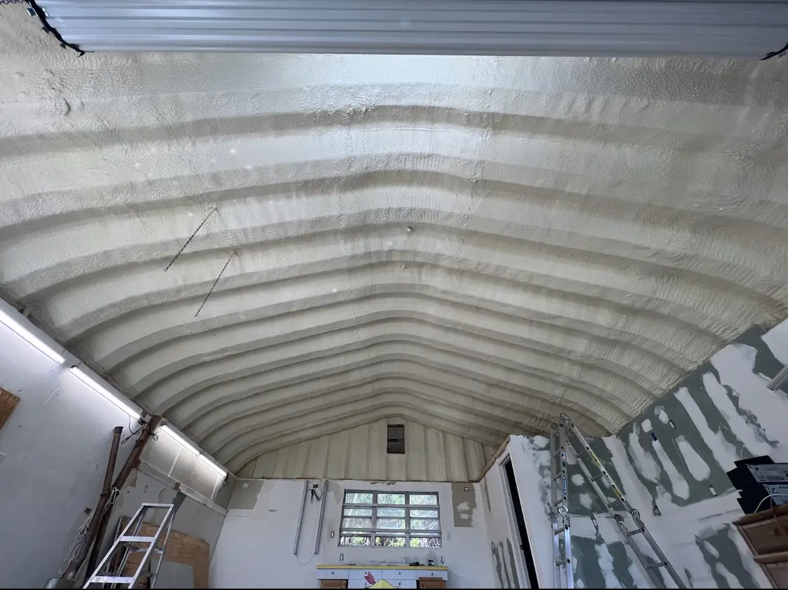 Spray polyurethane foam applied to the underside of a metal roof deck in Plover